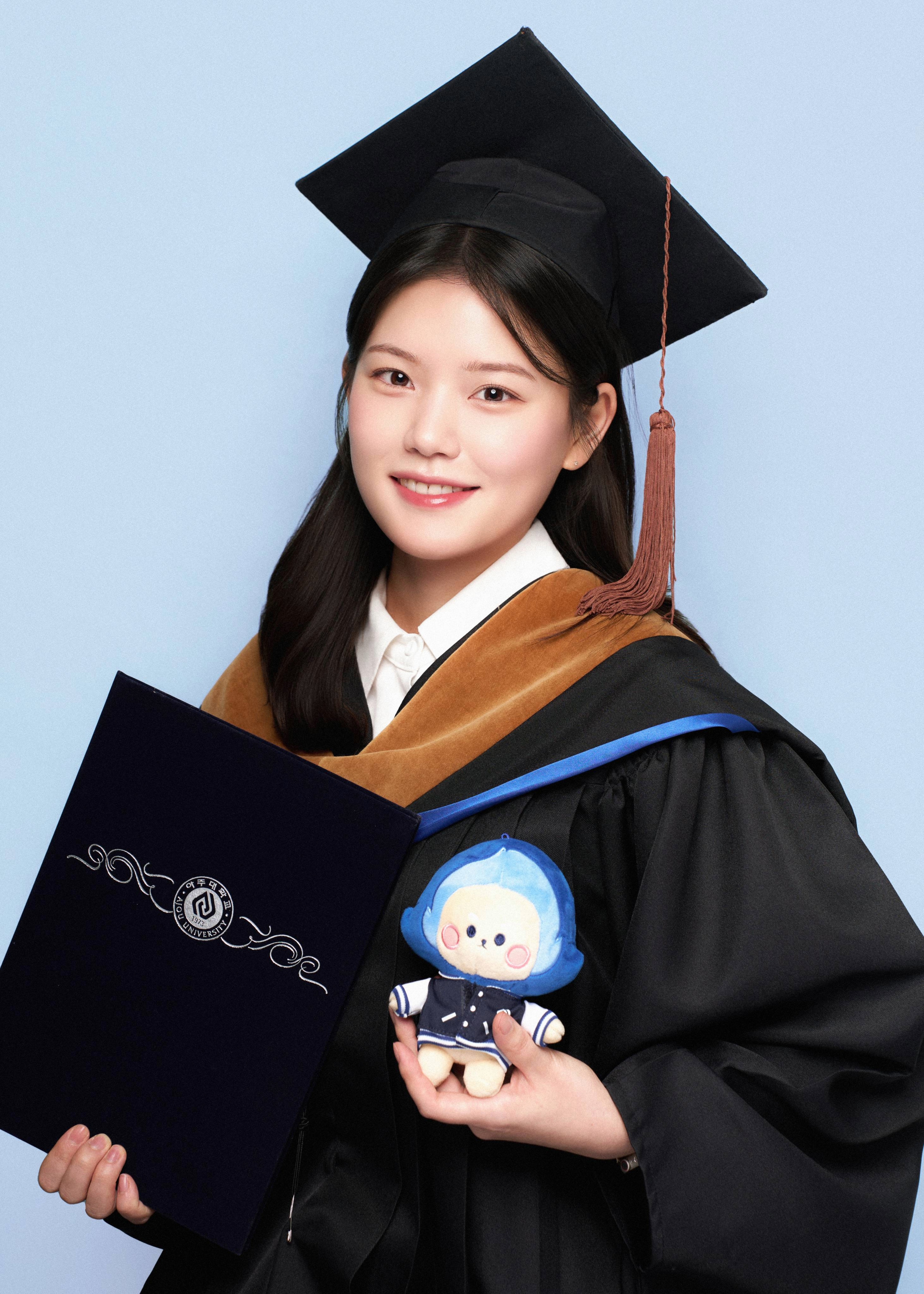 Jisun Hwang in a close-up portrait. She is smiling gently and looking toward the camera. The background is plain and neutral, and the overall tone feels warm and approachable.